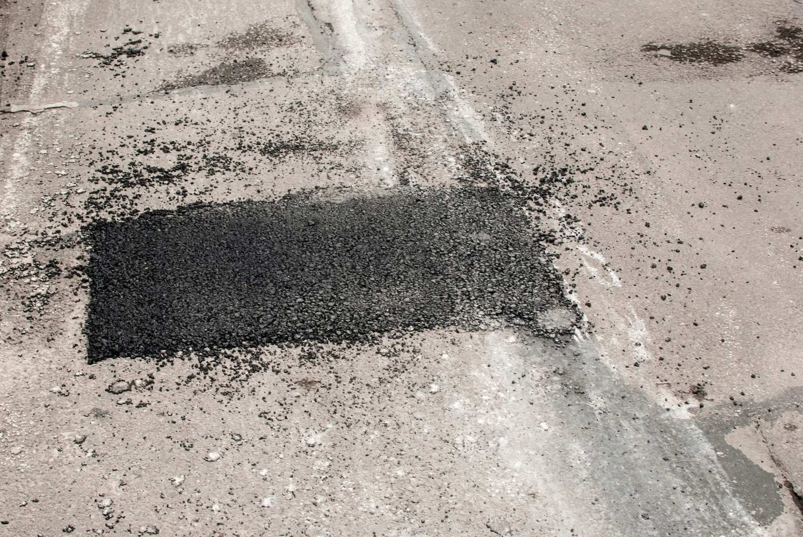 asphalt patching solution done in a cracked asphalt pavement in Naples, FL